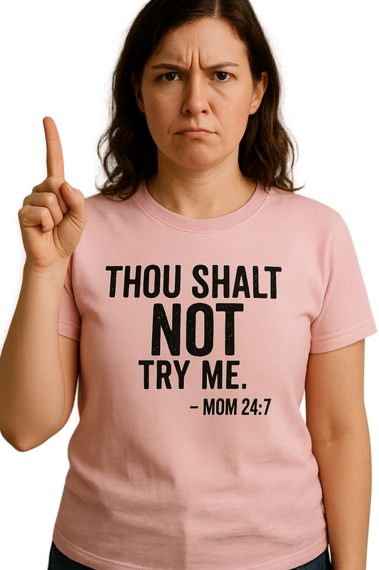 Person wearing a pink t-shirt with "Thou Shalt Not Try Me Mom 24:7" text and pointing upwards